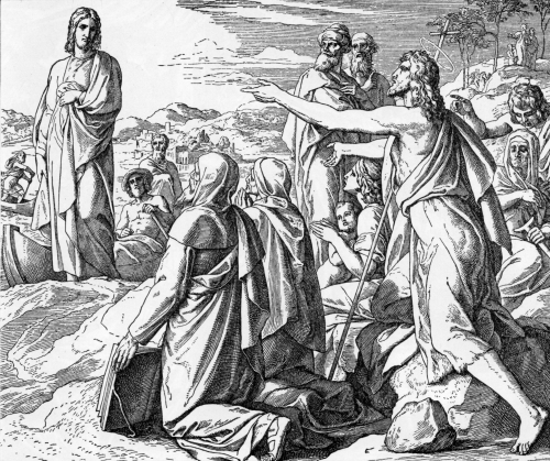 Jesus stands on a rocky shore delivering a sermon to a crowd gathered by the sea, with villagers listening attentively.